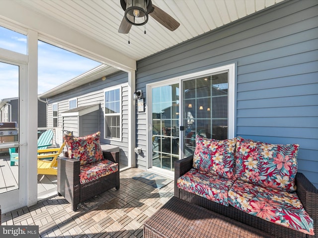 sunroom / solarium with a healthy amount of sunlight and a ceiling fan