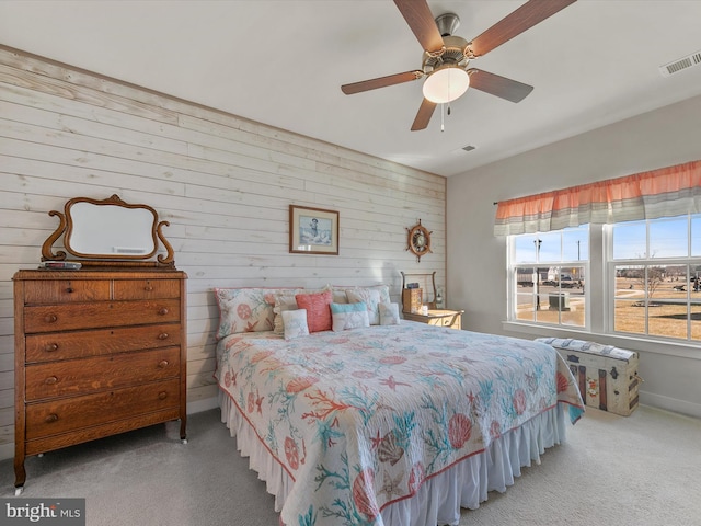 carpeted bedroom featuring visible vents and a ceiling fan