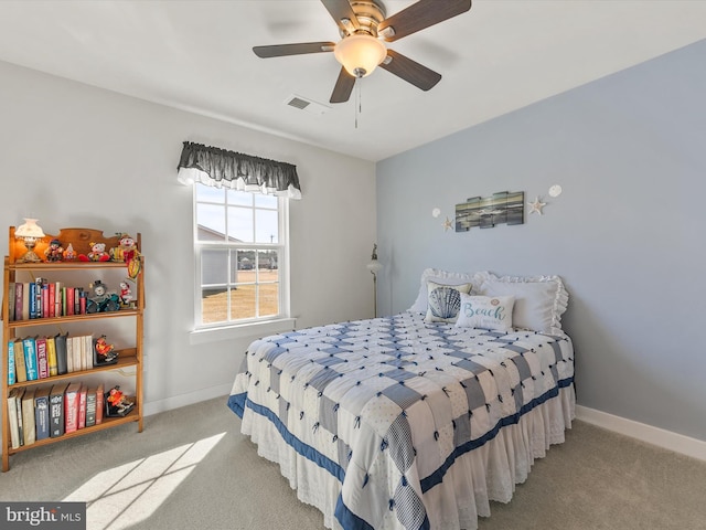 carpeted bedroom with baseboards, visible vents, and ceiling fan