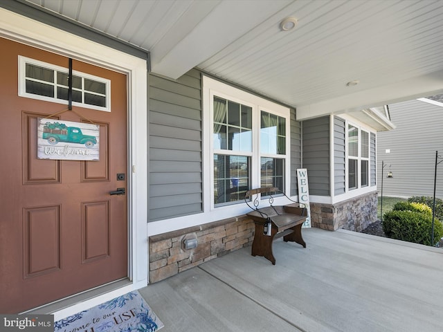 doorway to property featuring covered porch