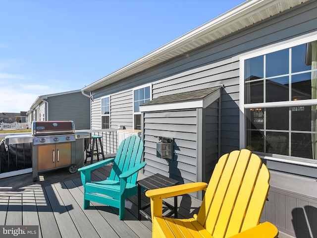 wooden deck with a grill