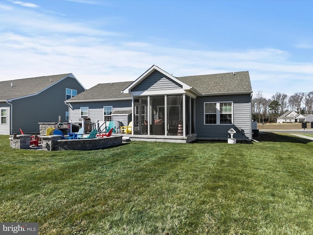 back of house with a yard, a shingled roof, and a sunroom