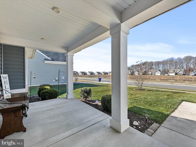 view of patio with covered porch and a residential view