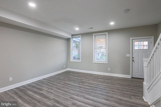 interior space with recessed lighting, visible vents, baseboards, stairway, and dark wood finished floors