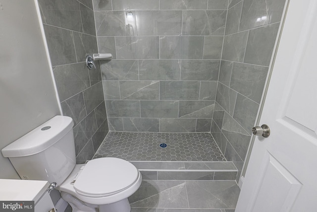 bathroom with vanity, a shower stall, and toilet