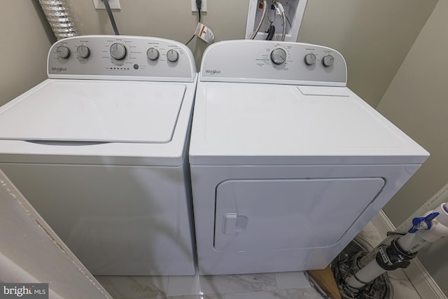 laundry room featuring marble finish floor, independent washer and dryer, and laundry area