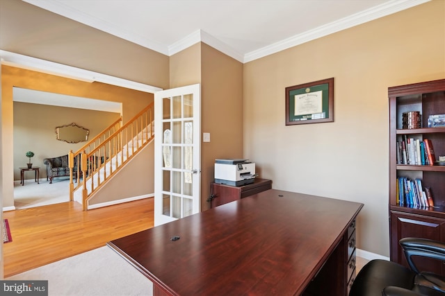 office space featuring crown molding, baseboards, and wood finished floors