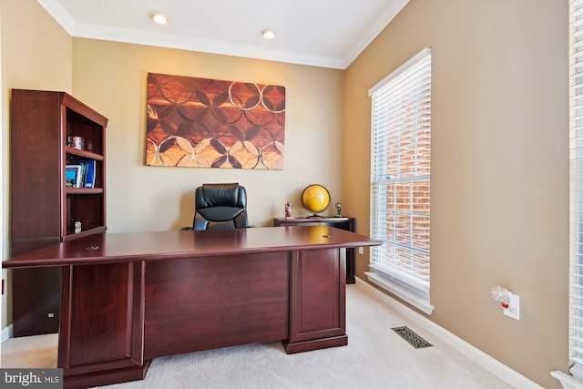 office area featuring visible vents, baseboards, light colored carpet, and crown molding