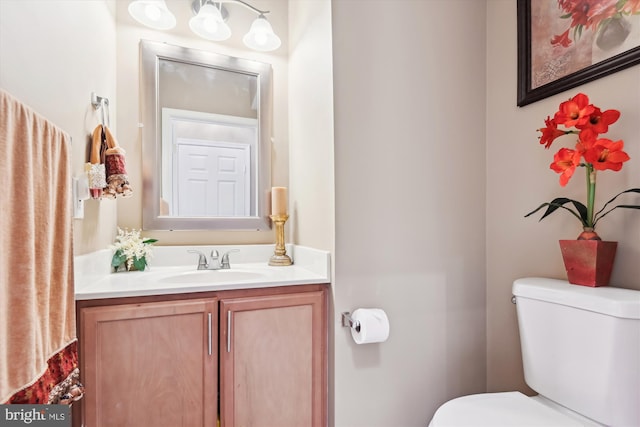 bathroom featuring toilet and vanity