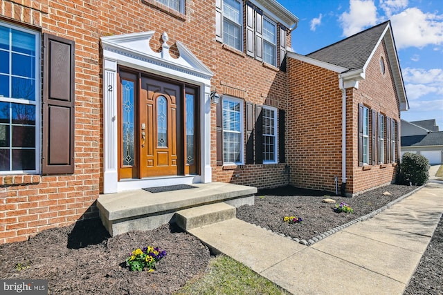 view of exterior entry with brick siding