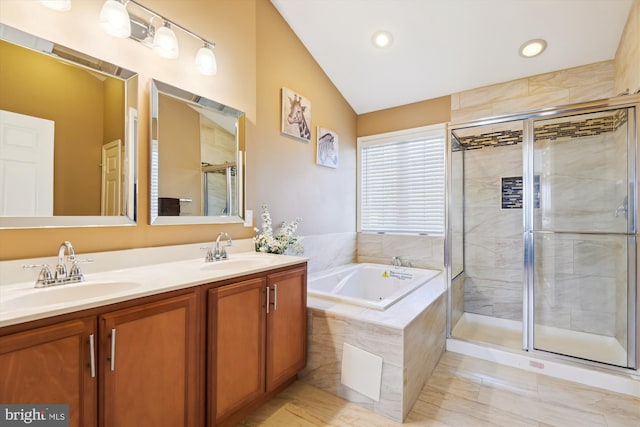 full bath with a garden tub, double vanity, a shower stall, and a sink