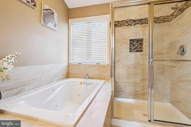 full bath featuring a tub with jets and a shower stall