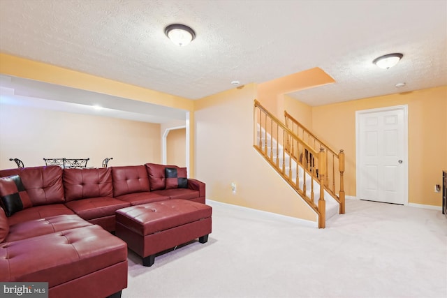 living area featuring stairs, carpet, baseboards, and a textured ceiling