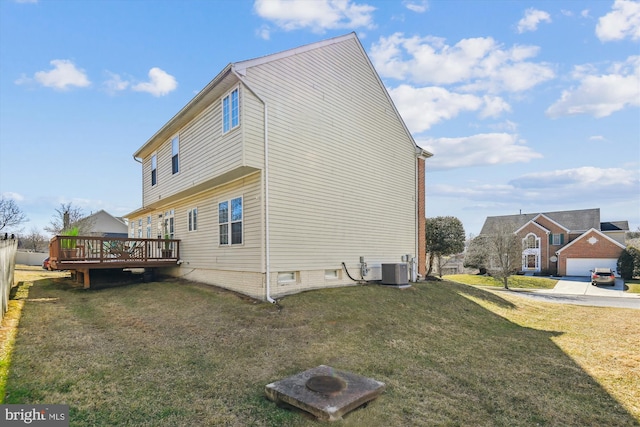 view of side of home featuring a yard, cooling unit, and a deck