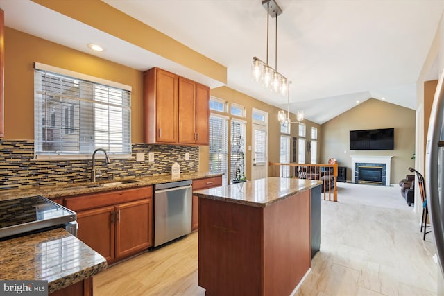 kitchen with light stone countertops, lofted ceiling, a sink, dishwasher, and a center island