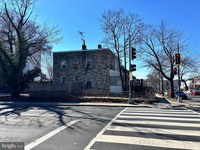 view of road with sidewalks, traffic lights, and curbs