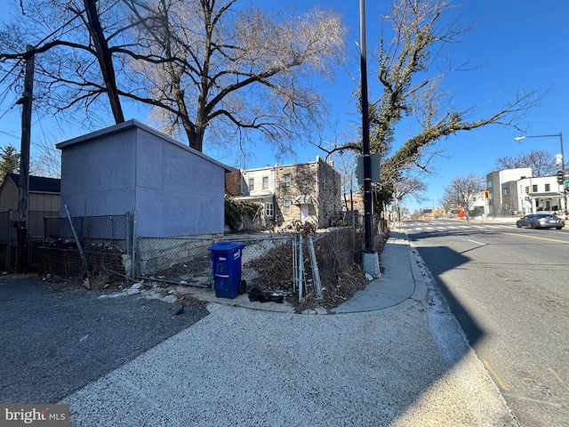 view of street featuring curbs, street lighting, and sidewalks