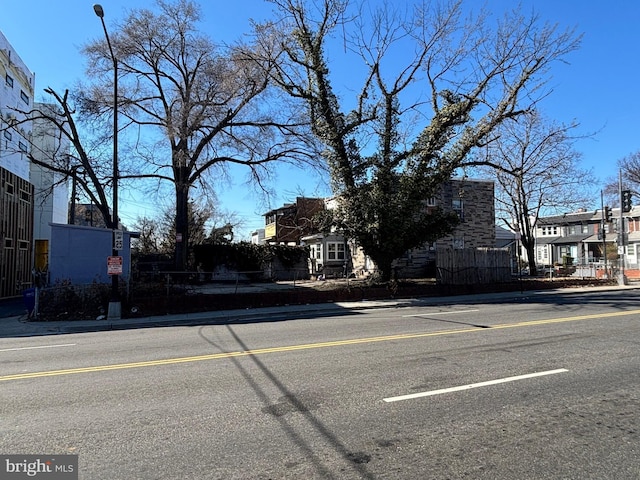 view of street with street lights, curbs, and sidewalks