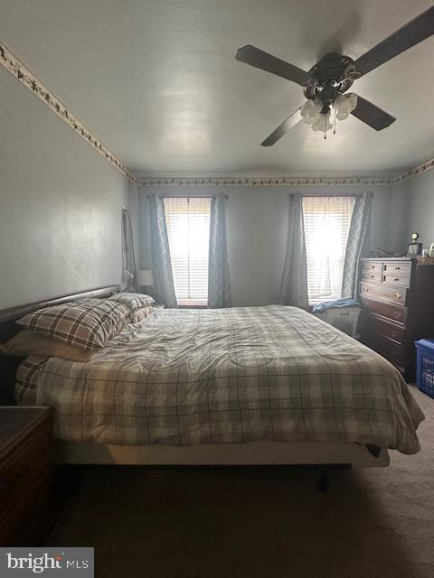 carpeted bedroom with ceiling fan