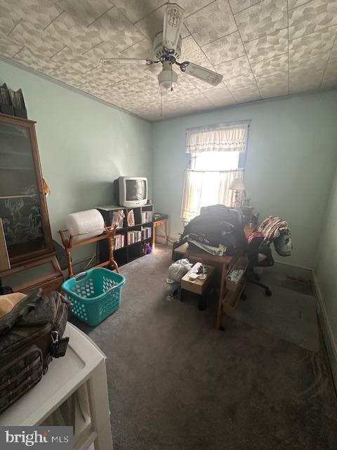 interior space featuring carpet and ceiling fan