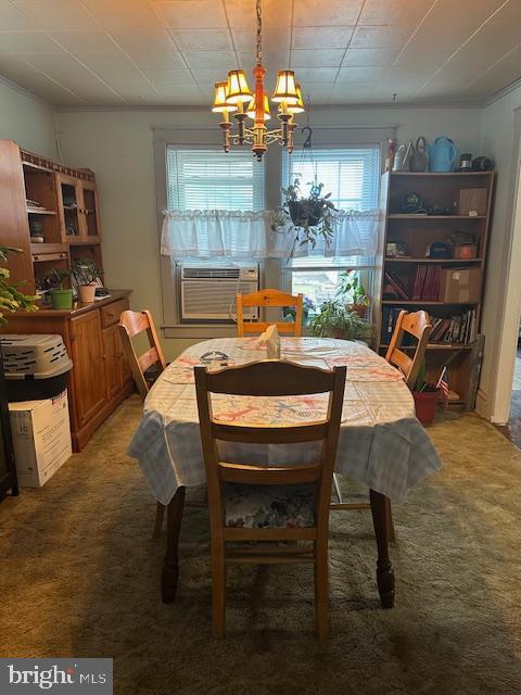 dining room featuring cooling unit, light carpet, and a notable chandelier