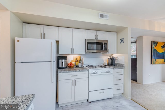 kitchen featuring white appliances, visible vents, marble finish floor, and white cabinets