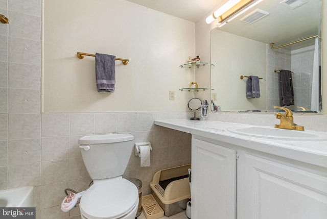 bathroom featuring toilet, visible vents, a shower, and tile walls