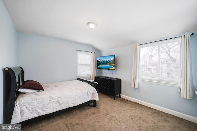 bedroom with vaulted ceiling, carpet flooring, and baseboards