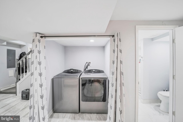 washroom with marble finish floor, electric panel, washer and dryer, baseboards, and laundry area