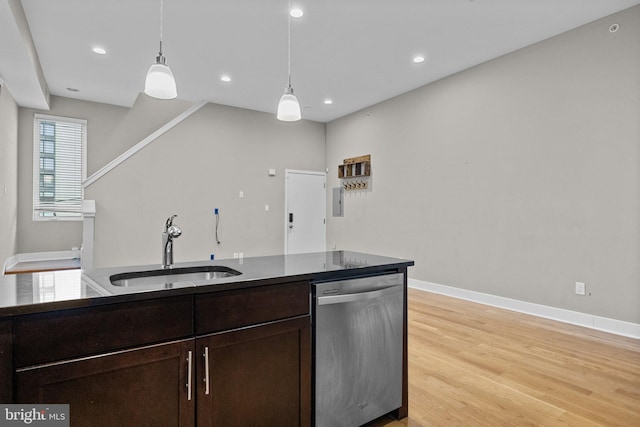 kitchen with dishwasher, dark countertops, light wood-style flooring, dark brown cabinets, and a sink