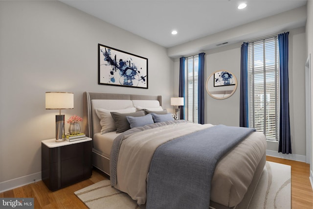 bedroom featuring light wood-type flooring, baseboards, and recessed lighting