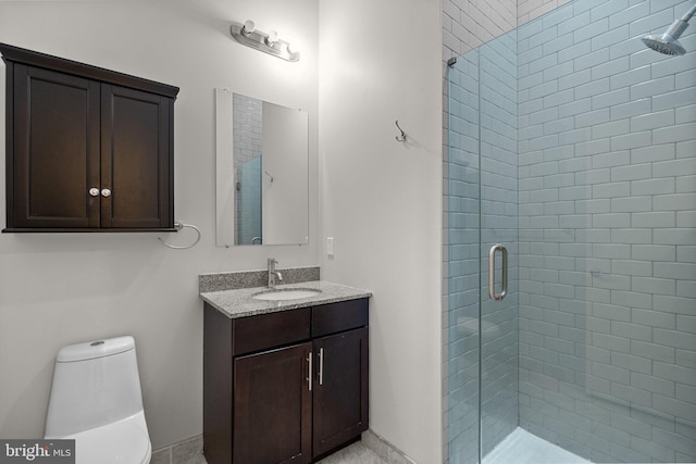 bathroom with toilet, a shower stall, and vanity