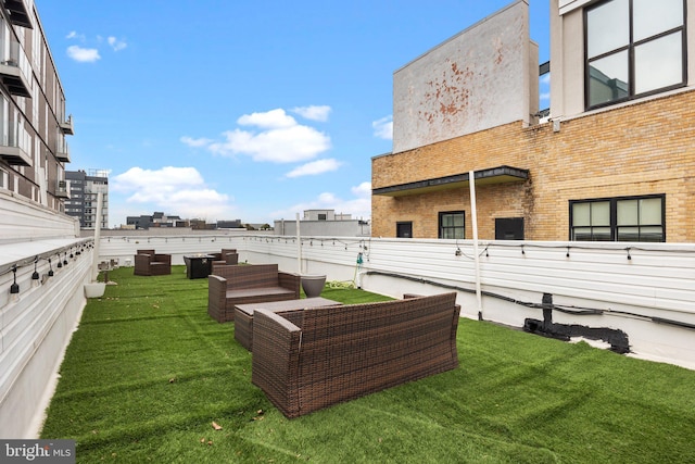 view of yard with an outdoor living space and a city view