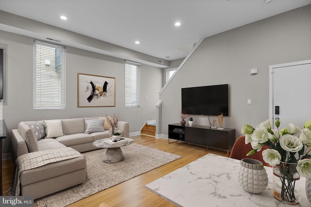 living area featuring stairs, wood finished floors, and recessed lighting