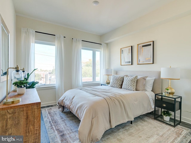 bedroom featuring baseboards and wood finished floors