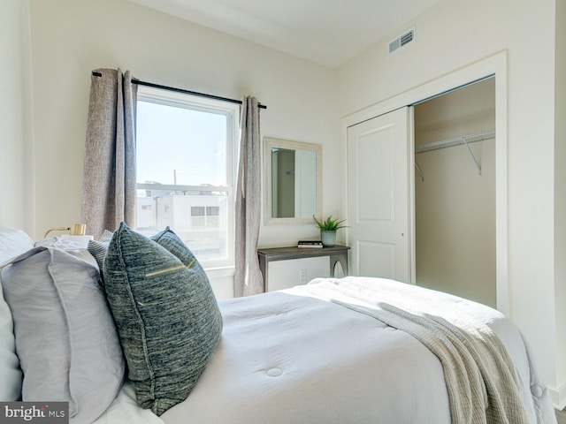 bedroom with visible vents and a closet