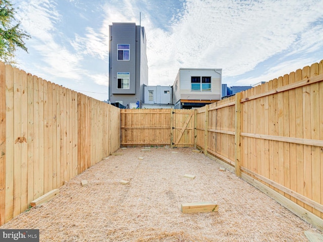 view of yard featuring a gate and a fenced backyard