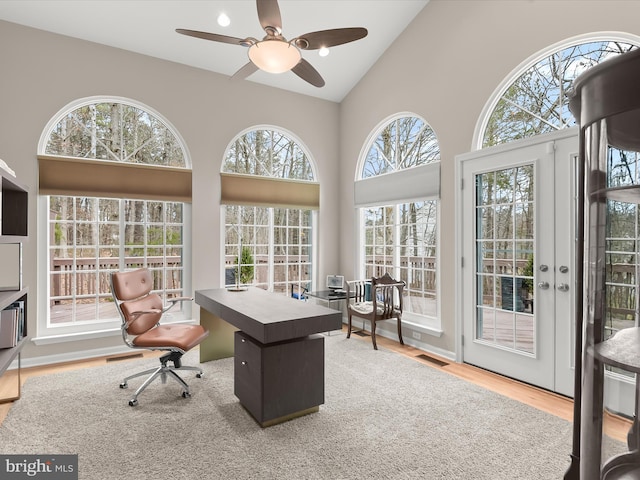 office with high vaulted ceiling, a ceiling fan, visible vents, and wood finished floors