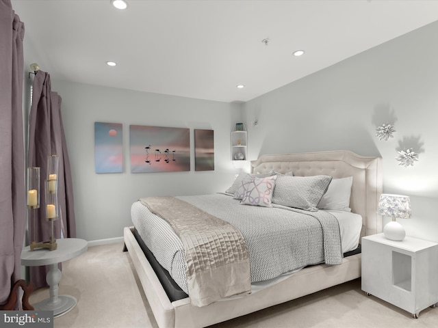 bedroom featuring recessed lighting, light colored carpet, and baseboards