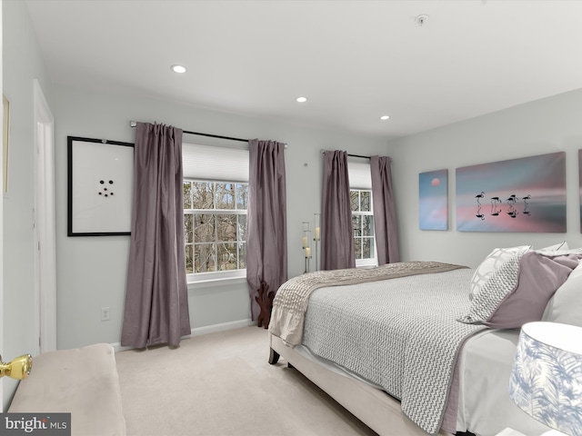 bedroom with baseboards, recessed lighting, and light colored carpet