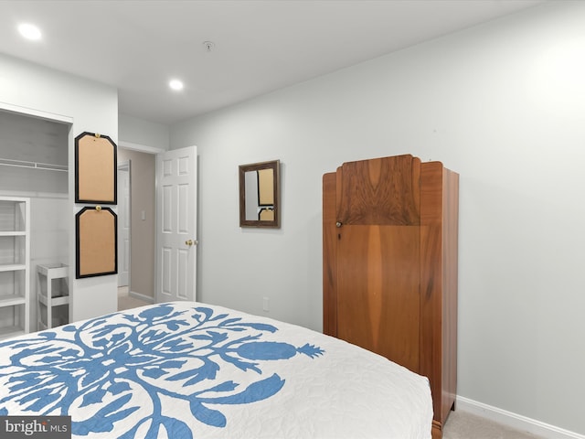 carpeted bedroom featuring baseboards and recessed lighting