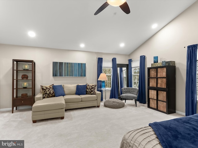 living area with vaulted ceiling, recessed lighting, and light colored carpet