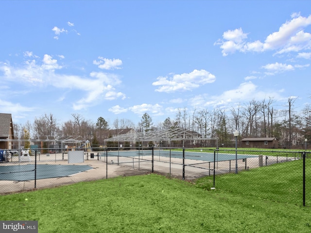 view of pool featuring a tennis court, a lawn, and fence