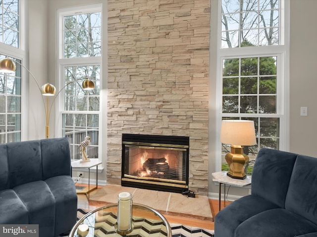 sitting room featuring a fireplace and wood finished floors