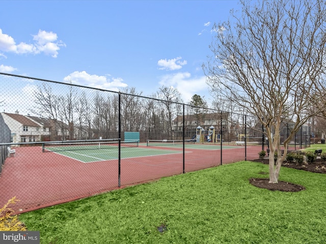 view of sport court featuring a yard and fence