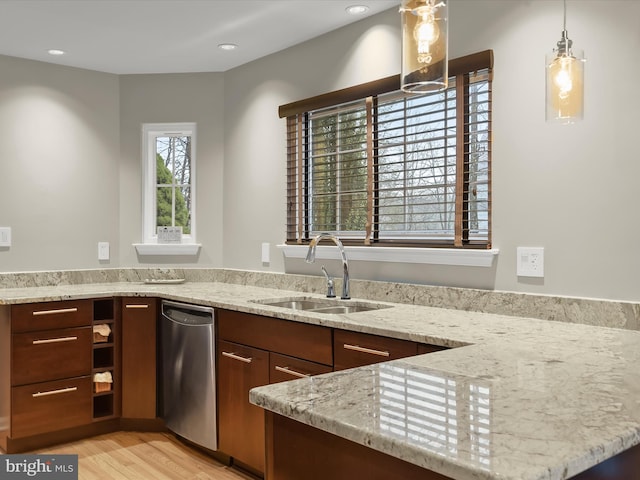 kitchen with light stone counters, recessed lighting, a sink, and light wood-style flooring