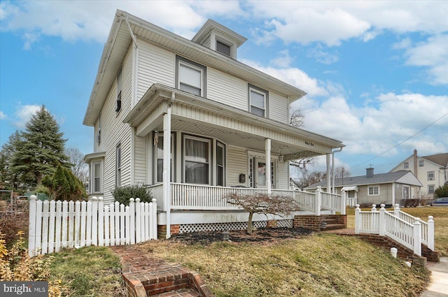 view of front facade featuring covered porch and fence