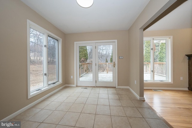 entryway featuring light tile patterned floors, visible vents, and baseboards