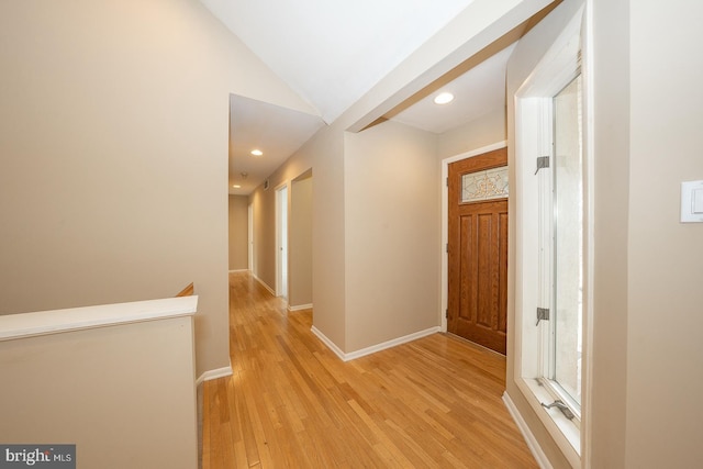 hallway with lofted ceiling, recessed lighting, an upstairs landing, light wood-type flooring, and baseboards