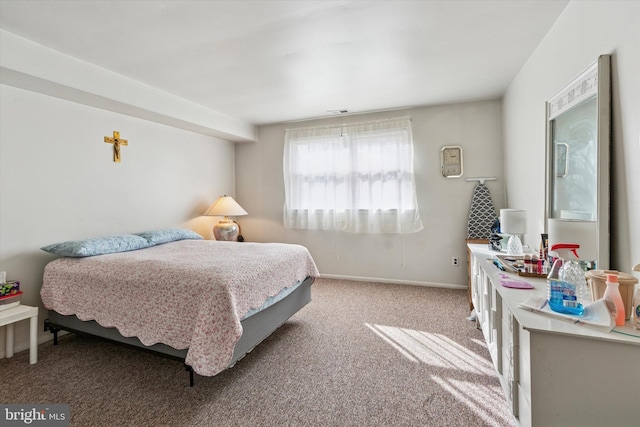 bedroom with carpet floors and baseboards